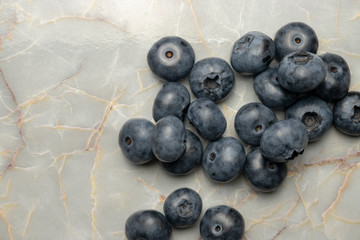 Blueberries on a marble kitchen table.