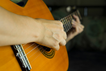 Female hands play the guitar. Hands and acoustic guitar.