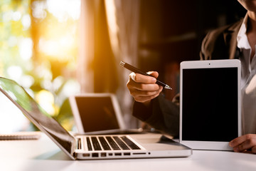 businesswoman using tablet screen mock up for your advertising text message,in the office blurred background view.