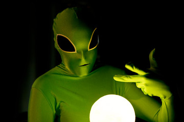 comical alien with glowing orb
