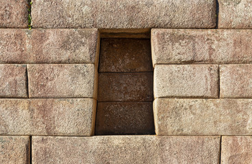 Trapezoid cavity in an Inca wall with perfect stonework, Machu Picchu, Cusco, Peru.