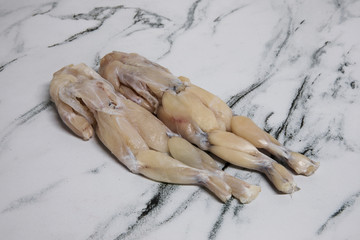 Cuisine. Raw bullfrogs meat. Skinned edible frogs, Pelophylax esculentus, ready for cooking. 