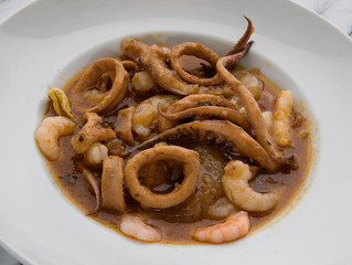 Gourmet. Dish presentation Seafood casserole with shrimps, prawns, scallops, squid, mussels and a spicy sauce.