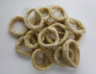 Culinary. Seafood preparation. Closeup of breaded squid rings ready to be fried. 