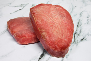 Gastronomy. Raw food. Fish. Bluefin tuna red steaks with vacuum packing, ready for cooking.