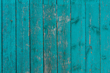 The surface of an old green, cracked wood plank as a texture. The boards are vertical.