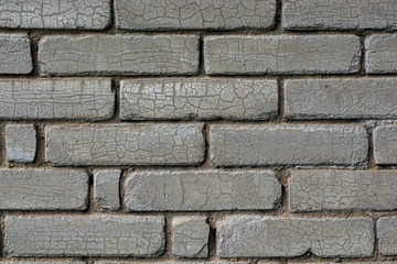 Gray brick wall background. The texture of the old brick wall is horizontal. Cracks form a...