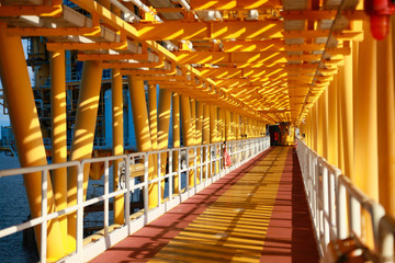 Walkway in offshore oil and gas plant. The construction platform in oil and gas industry or in power plant for walk and move equipment to working area.