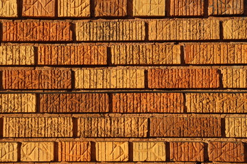 Textured brick wall background bright orange tan brown tones