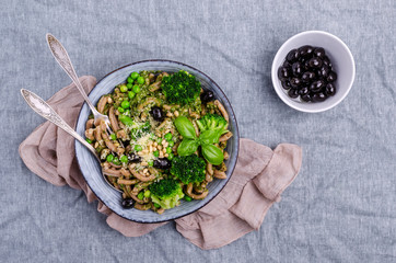 Traditional brown pasta with green vegetables