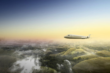Naklejka na ściany i meble Airplane flying in the air above the landscape