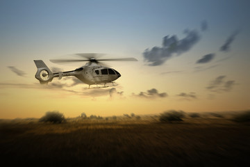 Helicopter flying in the air above the landscape