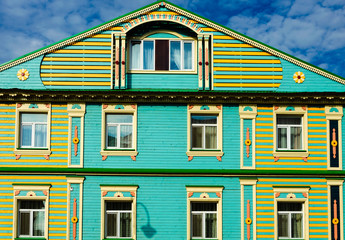 Old restored wooden house in the village on a summer day.