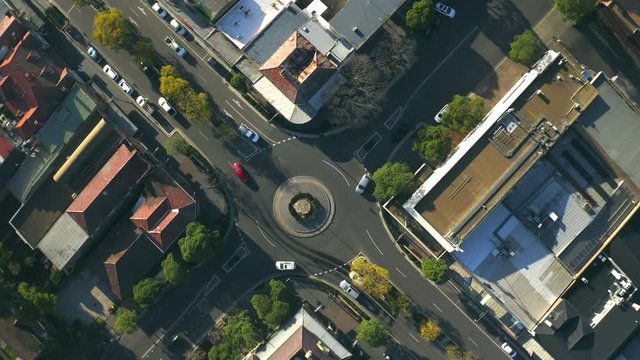 Twirling Aerial Top Down View Of Traffic Travelling Around A Round About Traffic Circle.