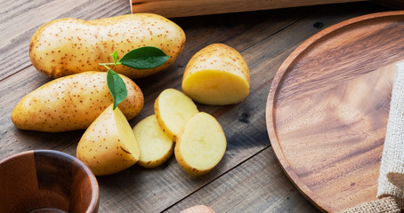 fresh potato on wood background, organic food
