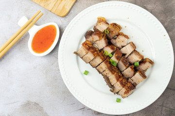 Oriental roast pork belly or char siew on white plate