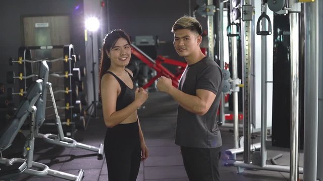 Asian couples posting post a photo with camera so exercise before running on the treadmill.Athletic exercises.Metaphor Fitness and workout concept exercise Health lifestyle muscle body of your health