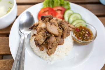 Top view of Thai white rice with streamed porks on white dish.