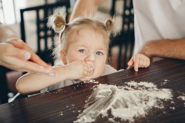 the baby makes cakes. the children were covered in flour. dinner at the bakery. feast in the kitchen
