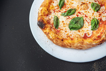 pizza on the black background, top view