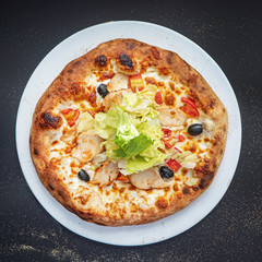 pizza on the black background, top view