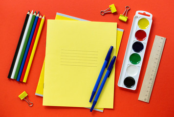 Back to school flat lay. Set of stationery on a red background, top view