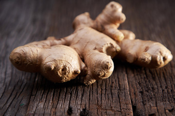 selective focus of ginger root on wooden background 