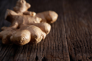 selective focus of ginger root on wooden background 