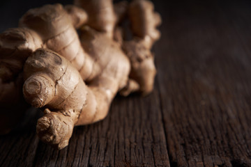 selective focus of ginger root on wooden background 