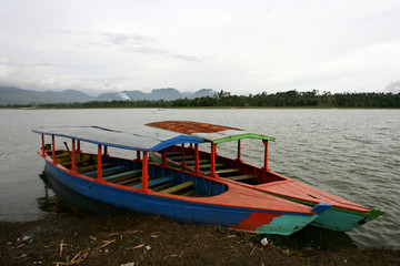 Fototapeta na wymiar Twol boats in Situ Cileunca, Pangalengan, West Java, Indonesia. The atmosphere of Lake Cileunca with a row of boats leaning back