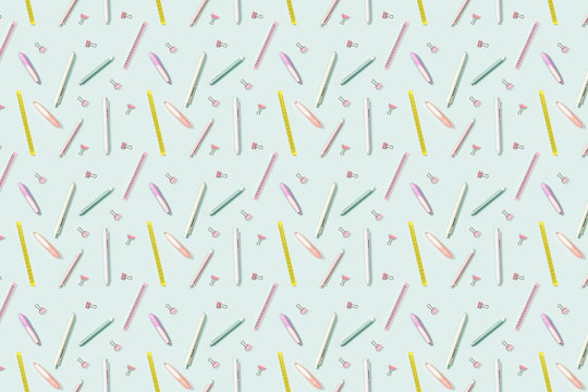School background with pattern from office supplies, color pencils, pens, puler, markers and metal paper clips.