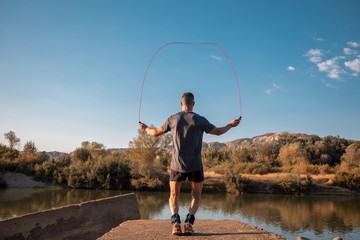 man training next to river © robcartorres