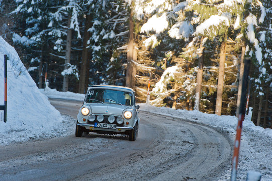 vintage mini cooper compact car on a snowy road in winter