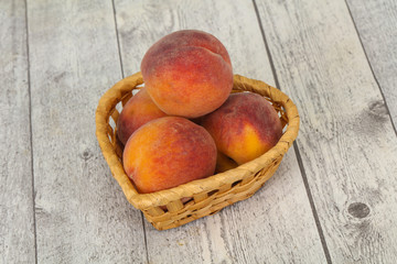 Peach heap in the wooden basket
