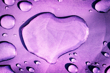 closeup of raindrops on a fabric, heart shaped drop