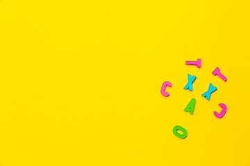 Face is depicted using plastic toy colored alphabet letters. Concept of humor that reflects the mood of a student or teacher. Banner with free space for text on the topic of education or psychology