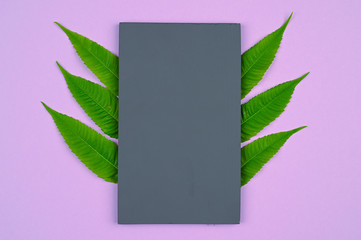 Grey wooden stand with green leaves frame.