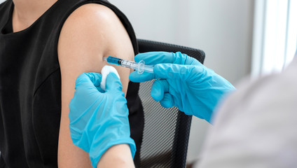Male doctors vaccinated with syringes to prevent epidemics at hospitals, health care, and medical...