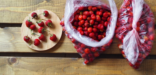 The process of preparing strawberries for storage in the freezer for future use.Fruit background.