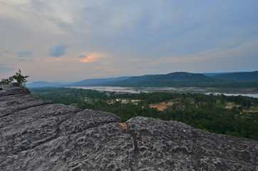 Naklejka premium Rock patio over tropical forest with cloudy sky in Asia