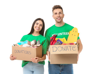 Volunteers with donations for orphans on white background