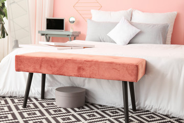Big bed and bench in interior of modern room