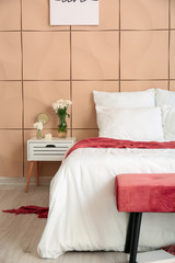 Big bed and bench in interior of modern room