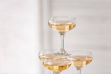 Tower made of glasses with champagne indoors