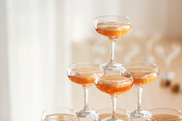 Tower made of glasses with champagne indoors
