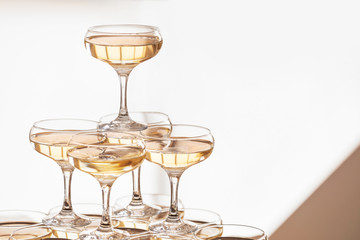 Tower made of glasses with champagne indoors