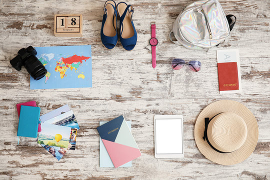 Set of travel accessories on wooden background