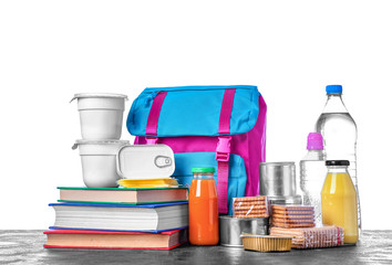 Schoolbag with different products on table against white background. Concept of Backpack Food Program