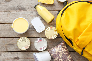 Schoolbag with different products on table. Concept of Backpack Food Program