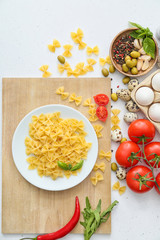 Dry pasta with products on table